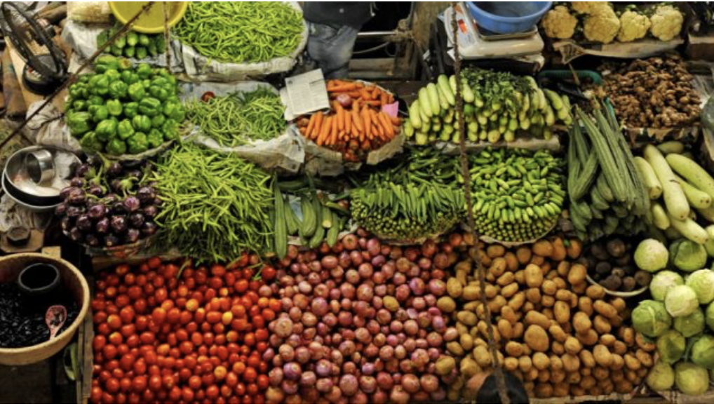 A vibrant Goan market stall brimming with fresh vegetables, fruit and spices
